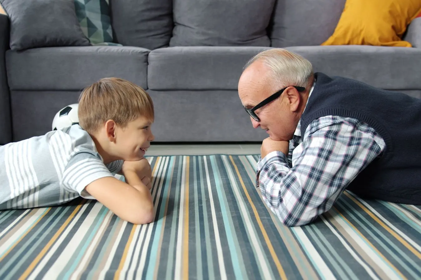 A grandfather and his grandson together at home