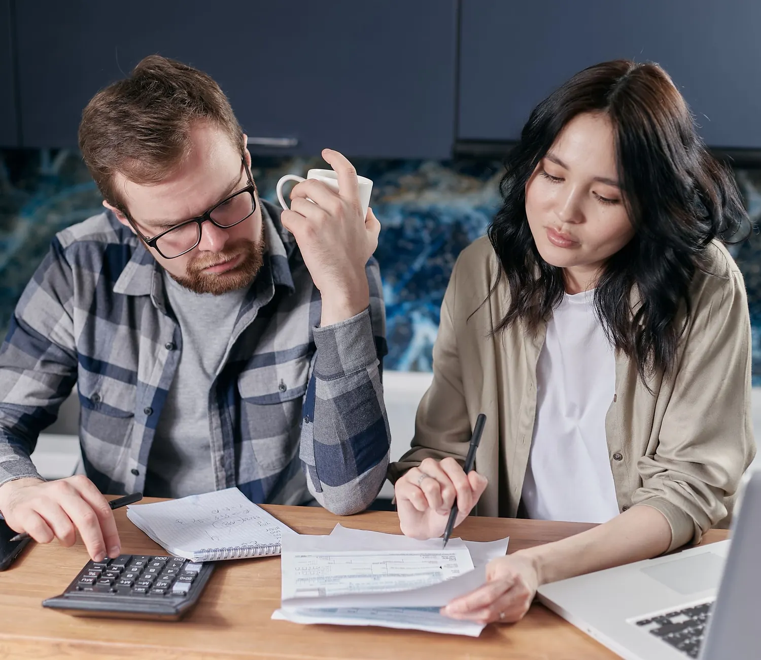 A couple going through their paperwork at the kitchen table