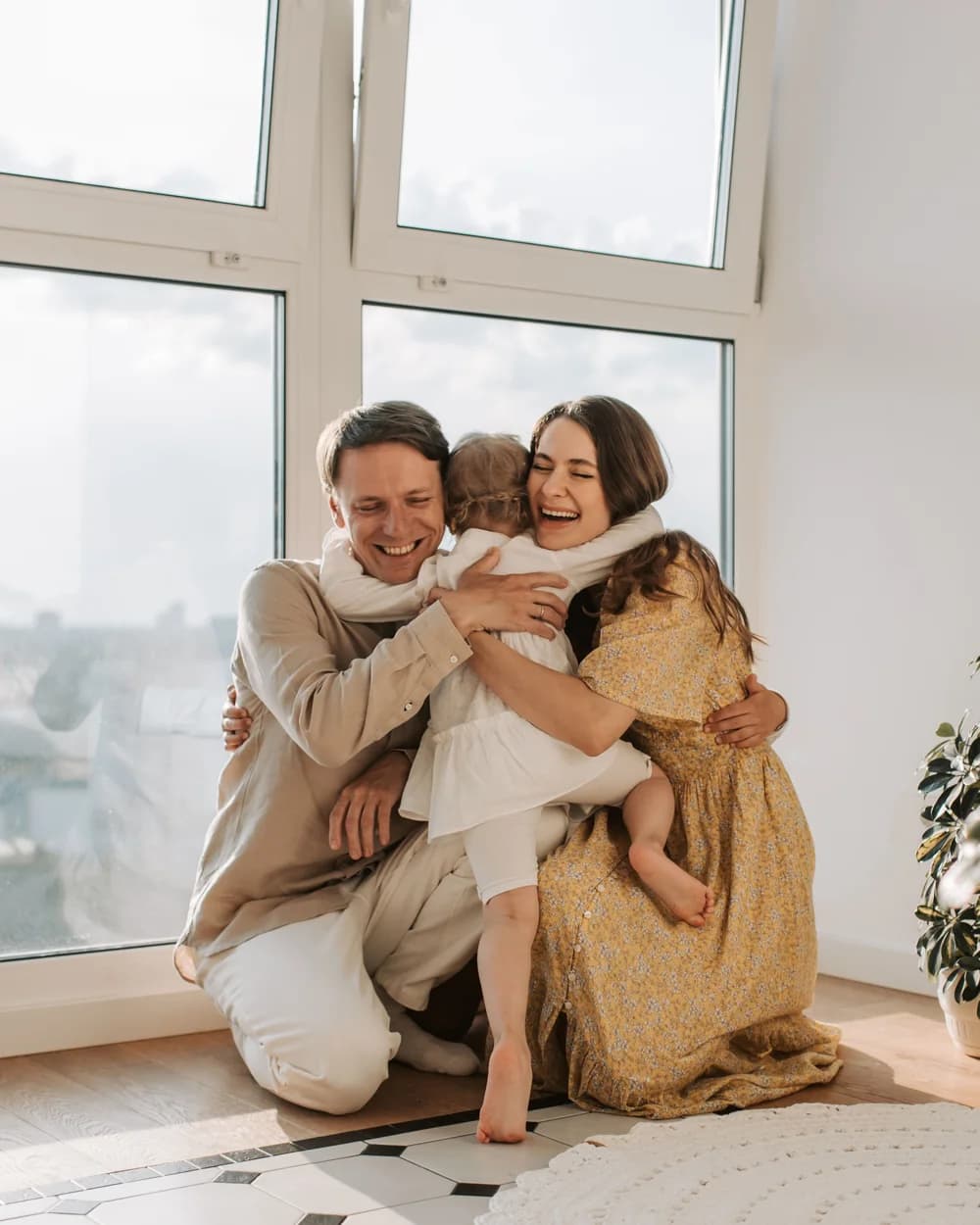 A young family together in a sunlit room