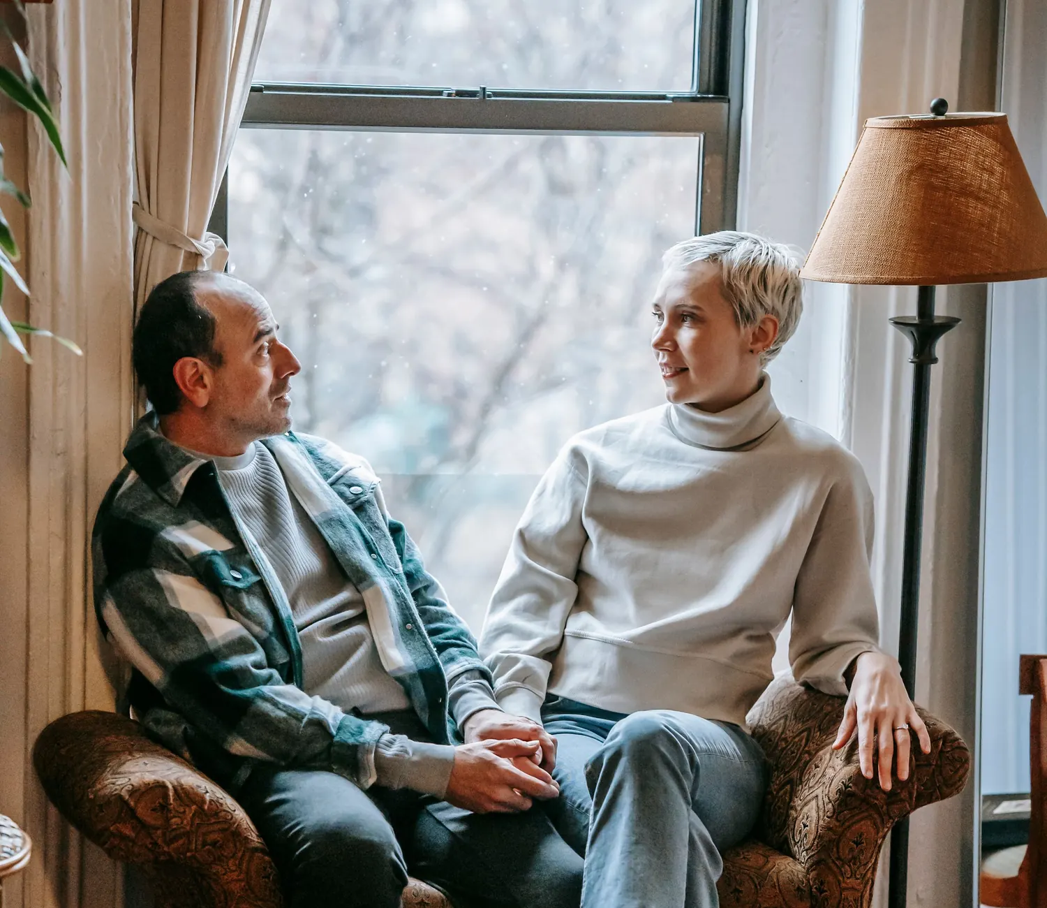 A couple in their sixties talking together at home